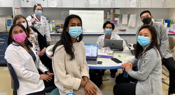 medical students in white lab coats facing camera
